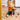 Child playing with colorful toys on a rug in a room.